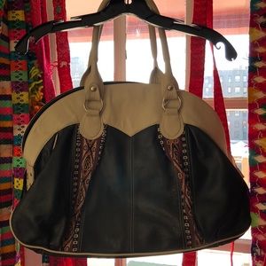 Cowhide and hand woven wool on the sides.